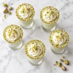 Overhead Pistachio Shot Recipe with five creamy non-alcoholic dessert shots and pistachio rims