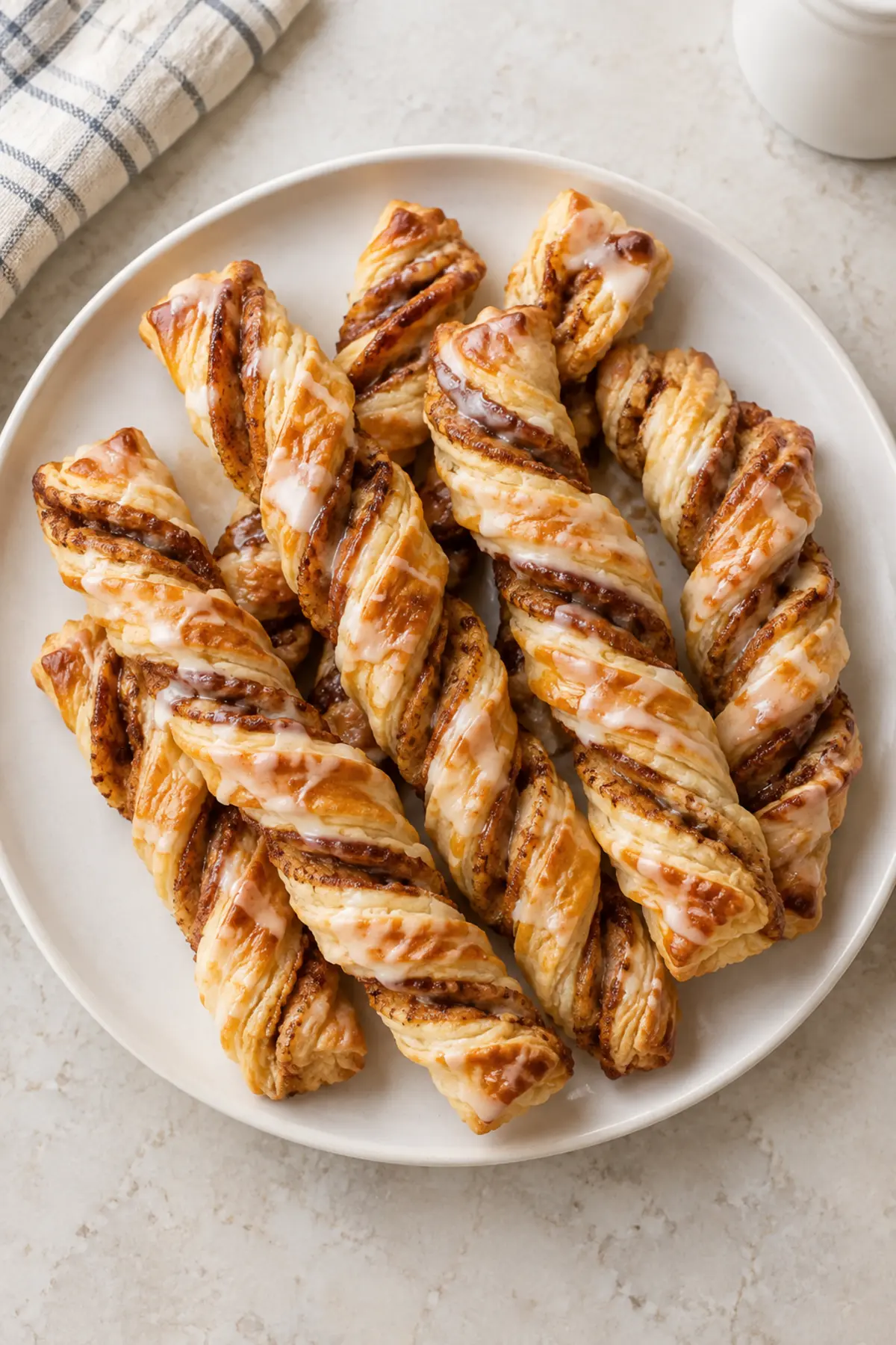 Overhead view of golden pumpkin pie twists with vanilla glaze